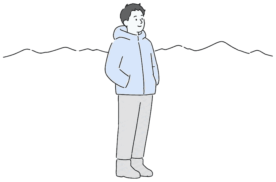 山の稜線をながめる人