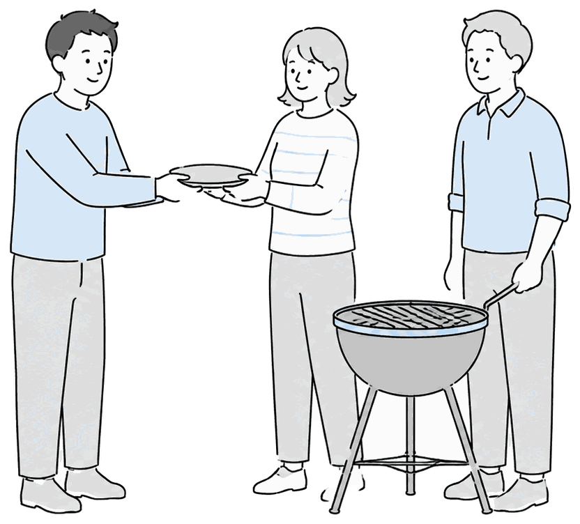 BBQコンロを囲んで皿を渡す人たち
