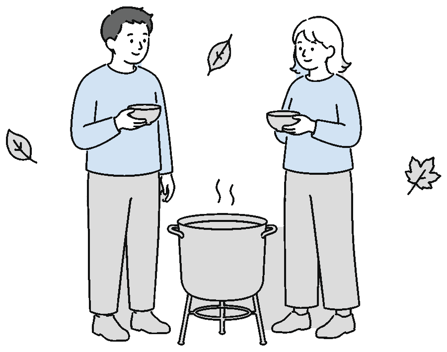 大鍋を囲んで芋煮を味わう人たち
